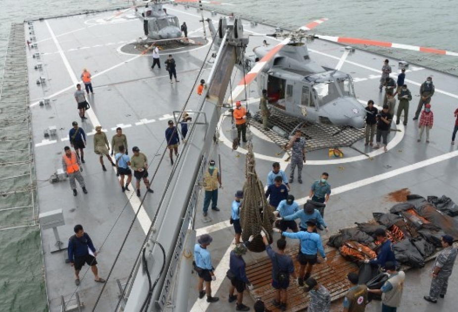 Divers find bodies belted in seats near AirAsia fuselage