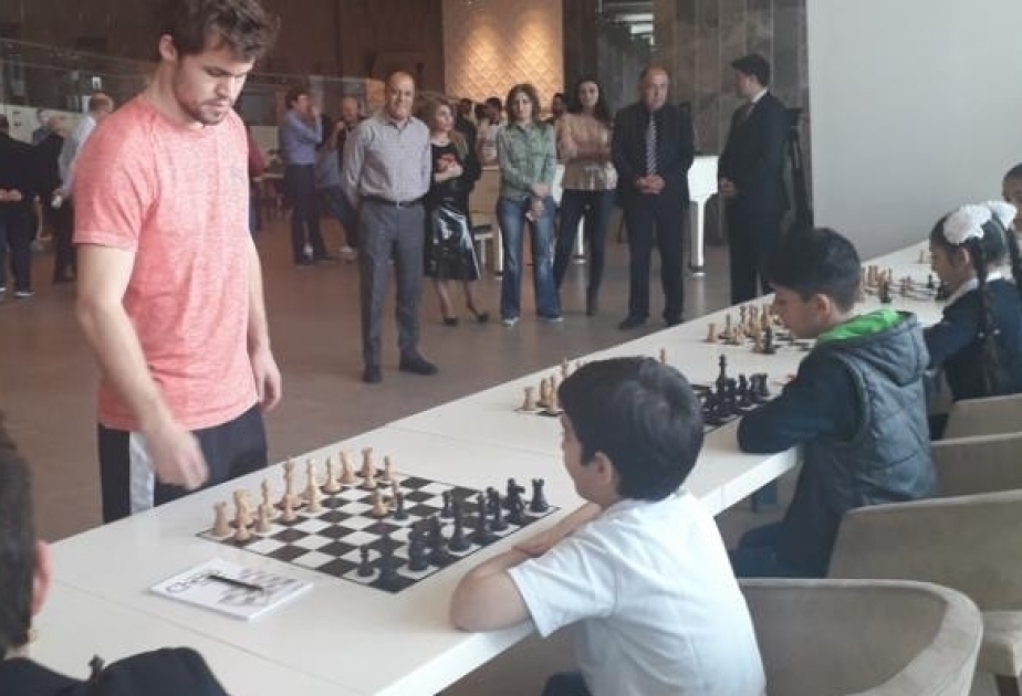 Magnus Carlsen plays chess with children from Nagorno-Karabakh region of Azerbaijan
