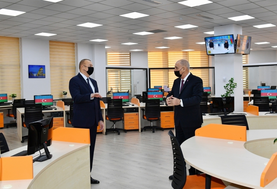 President Ilham Aliyev watches the new AZERTAC building