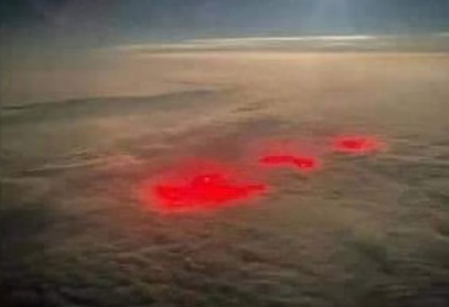 Bizarre red lights produce a glowing sky over Atlantic Ocean