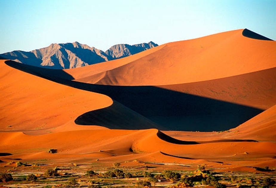 Sossusvlei - Namibia’s unspoilt desert beauty, salt and clay pan surrounded by immense red dunes
