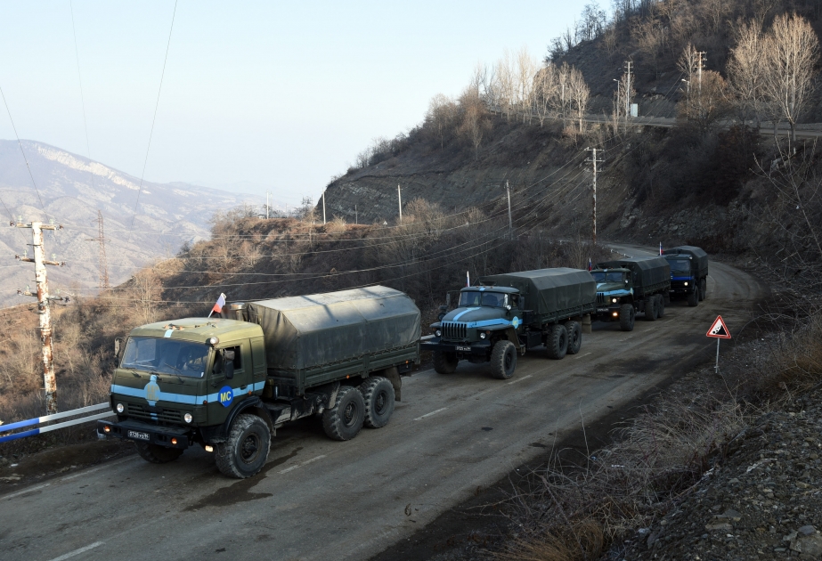 Quatre véhicules militaires transportant du ravitaillement traversent librement la route Latchine-Khankendi