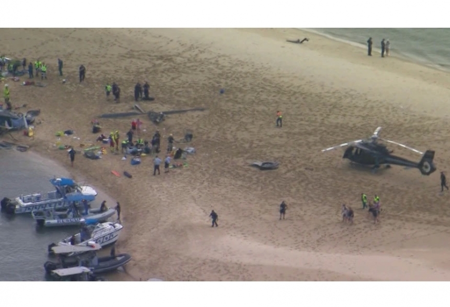 Helicopters collide over Australian beach, 4 passengers dead