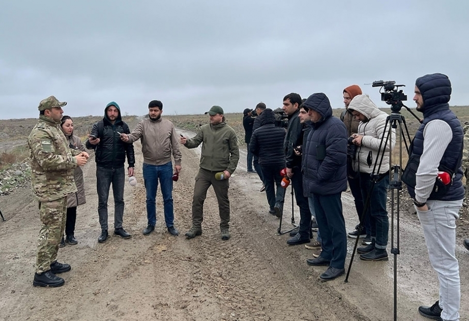 Media representatives watch the activities of engineer-sapper units