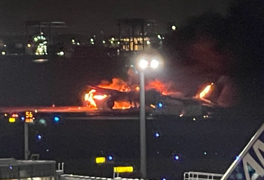 Japan Airlines plane in flames on runway at Tokyo's Haneda airport