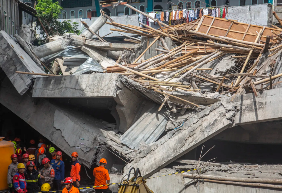 Three dead, dozens trapped after Indonesian school collapses on students