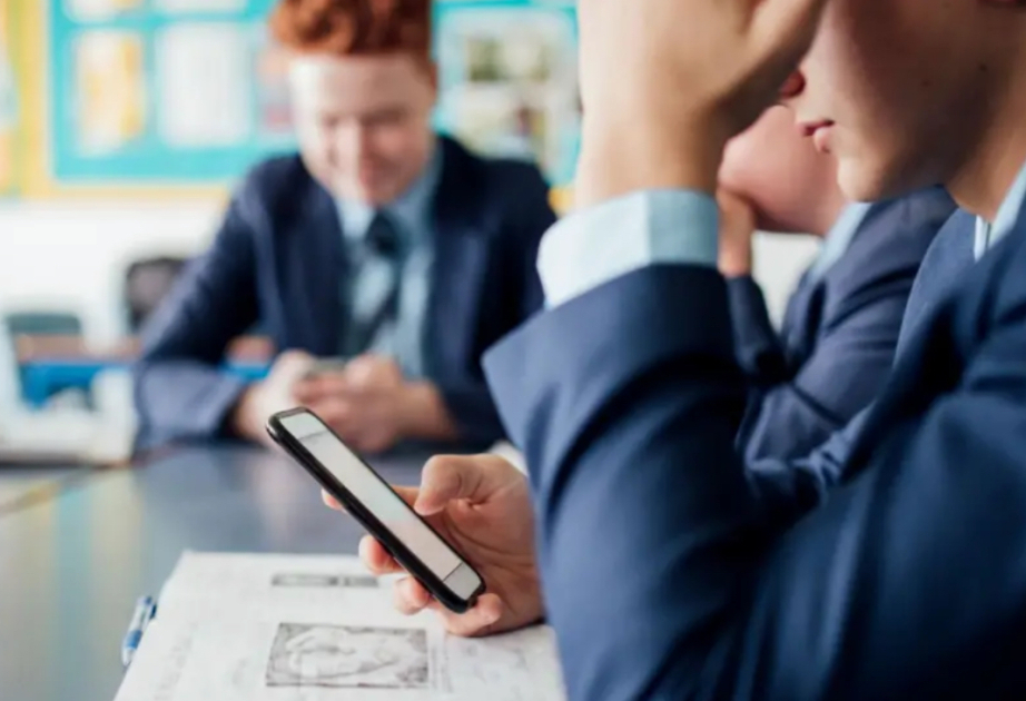 Phones to be banned in schools by law in England under government plans